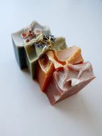 Four assorted mini soap bars.