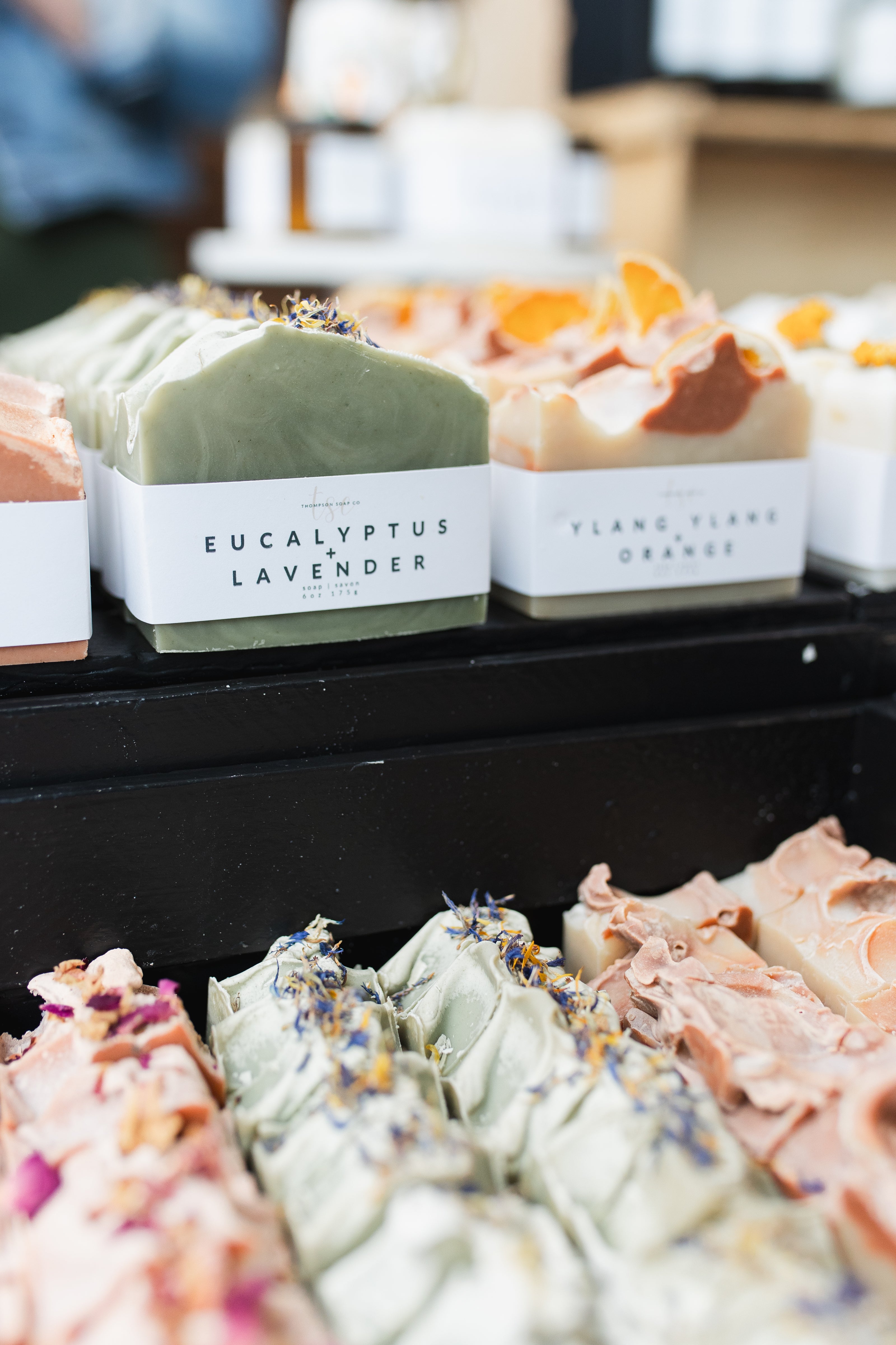 Assorted soaps with visible labels on a shelf